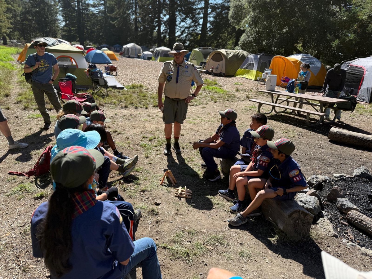 Scout leader teaching skills at a campout