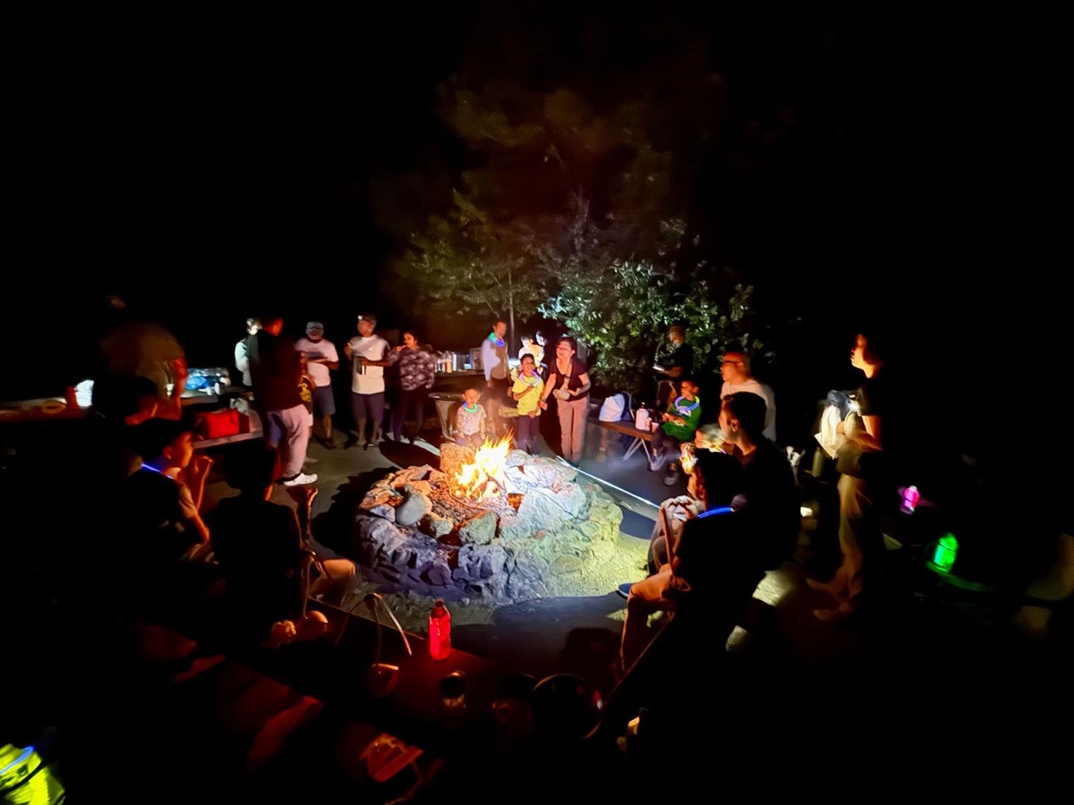 Pack gathered around a campfire at night