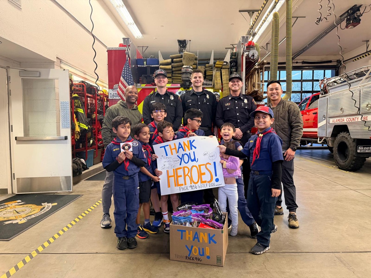 Pack 986 Wolf Den delivering popcorn to firefighters