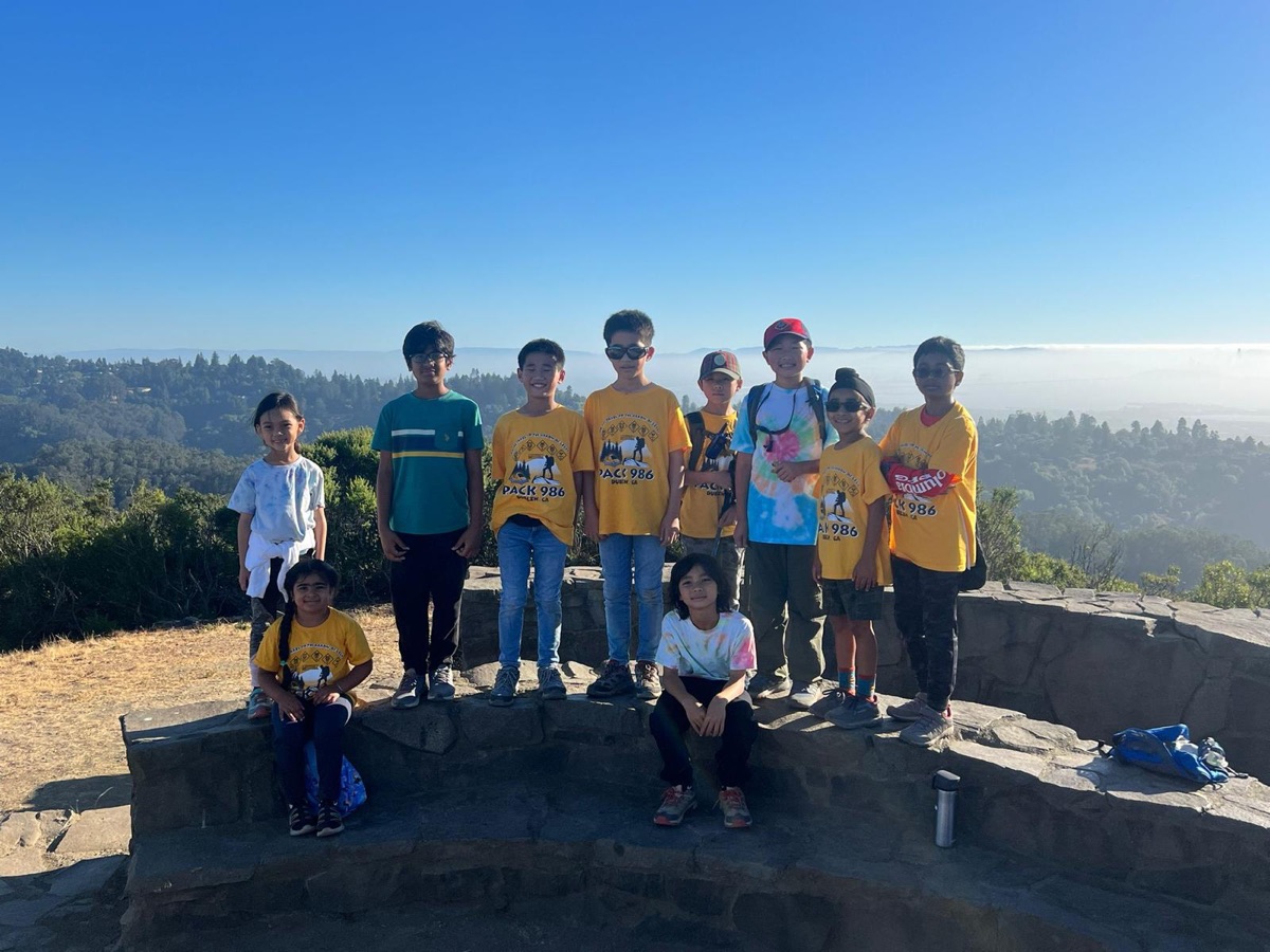 Scouts at the top of a hill with a view of the valley