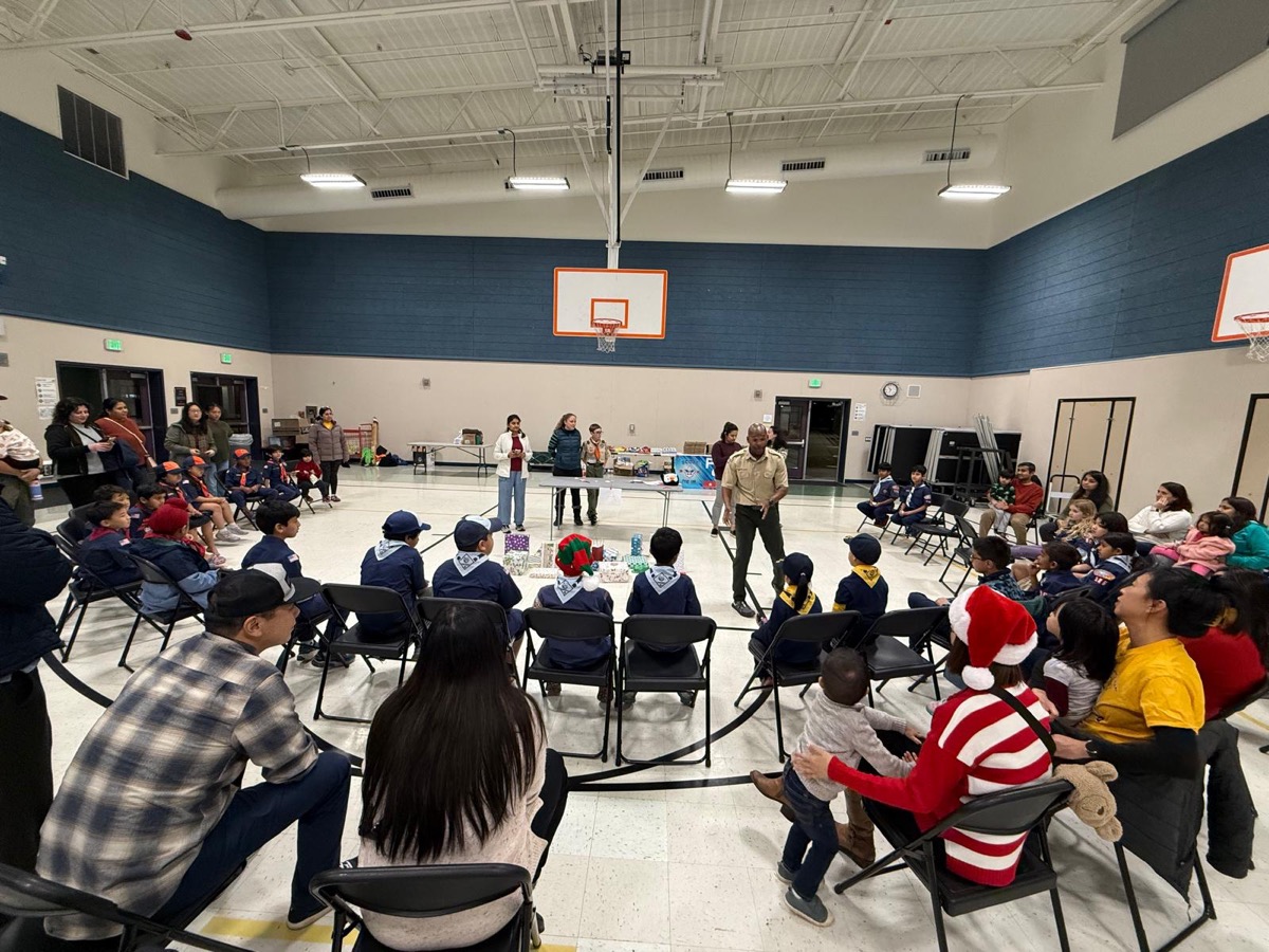 Pack 986 holiday pack meeting with scouts in a gym circle