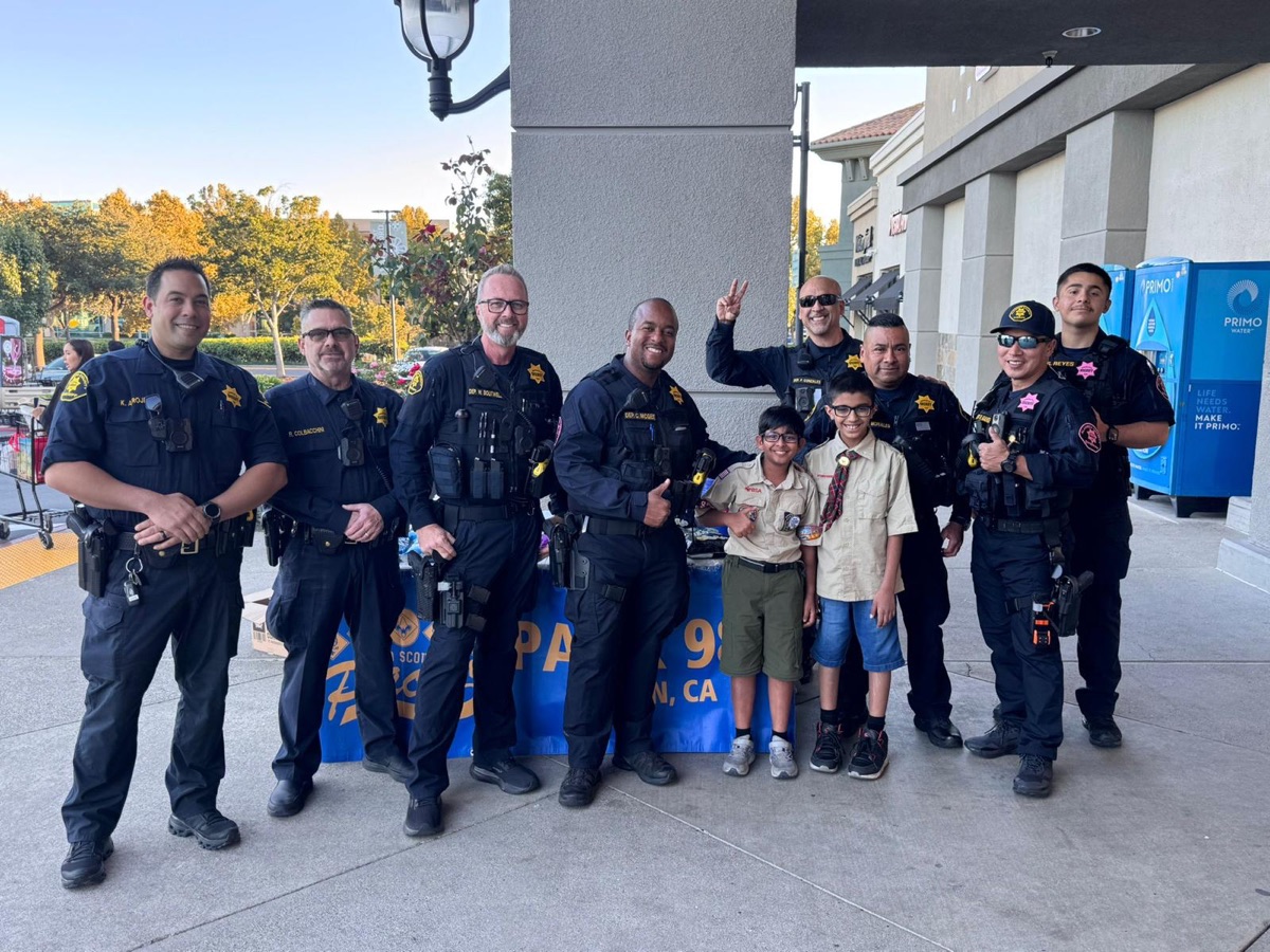 Scouts with sheriff deputies during popcorn sales