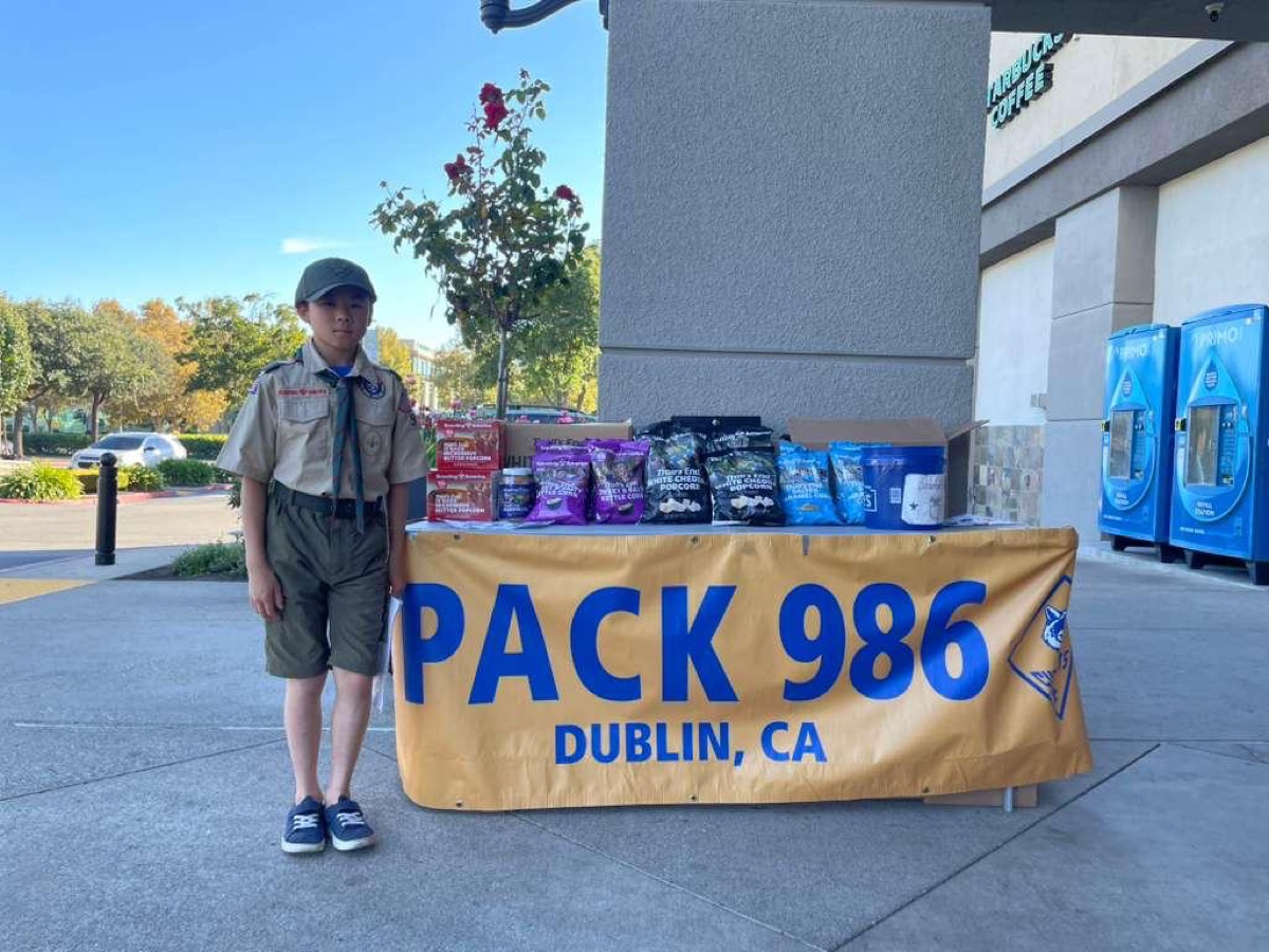 Scout at a Pack 986 popcorn sales table
