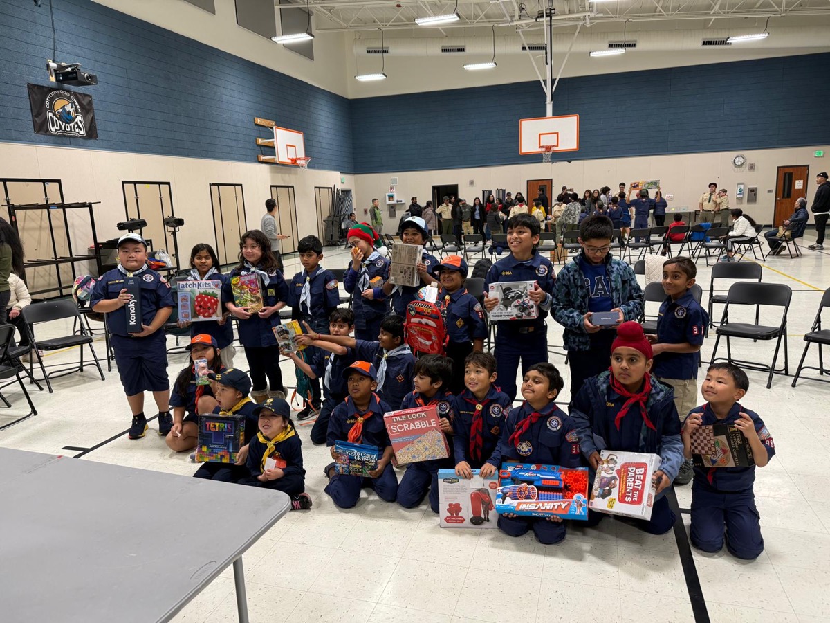 Scouts holding gifts from the Pack 986 White Elephant exchange